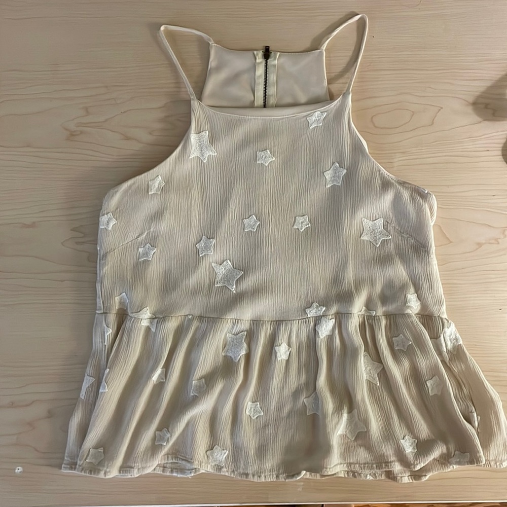 tan tank top with white stars / flows out at the bottom